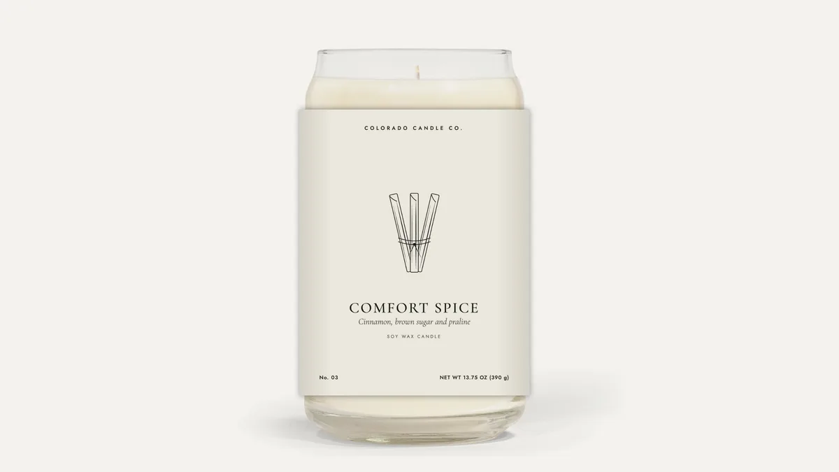 Comfort Spice soy candle in a tall clear glass jar
