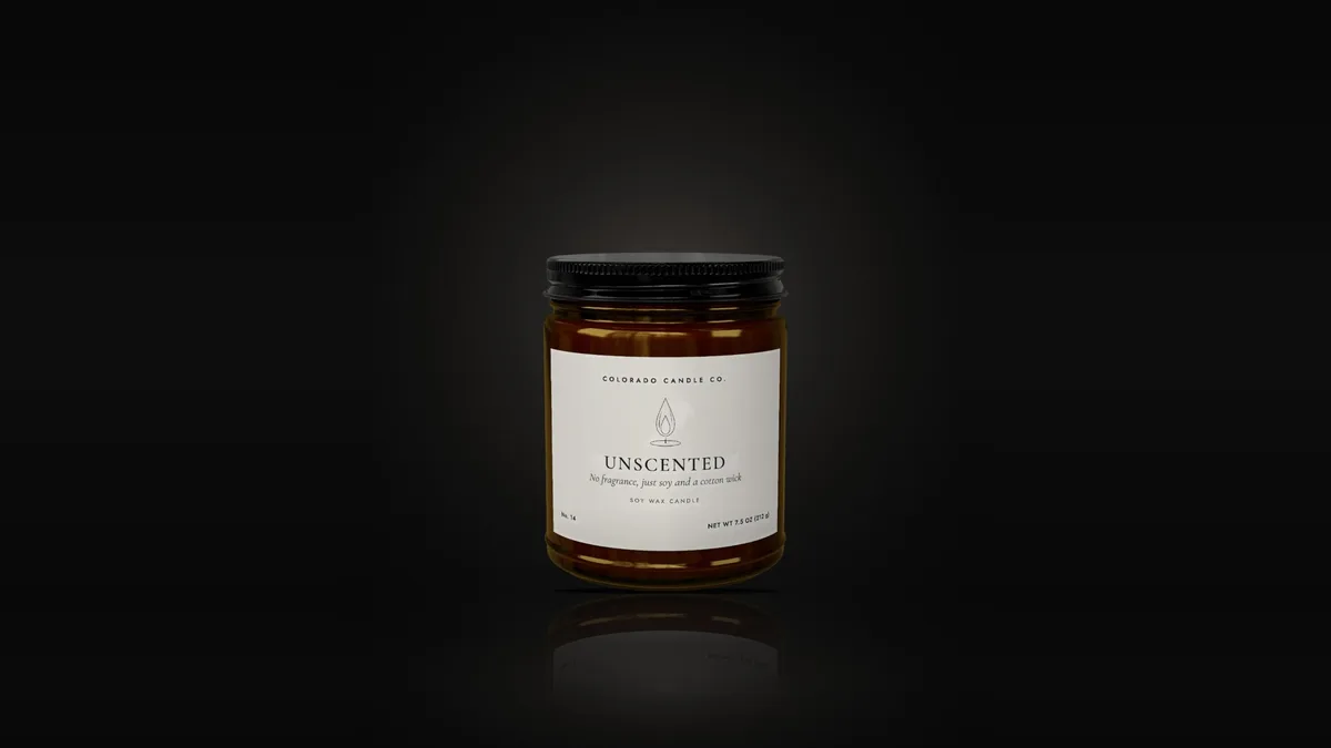 Unscented soy candle in an amber glass jar with a black lid