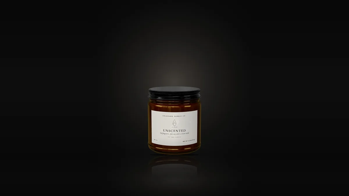 Unscented soy candle in an amber glass jar with a black lid