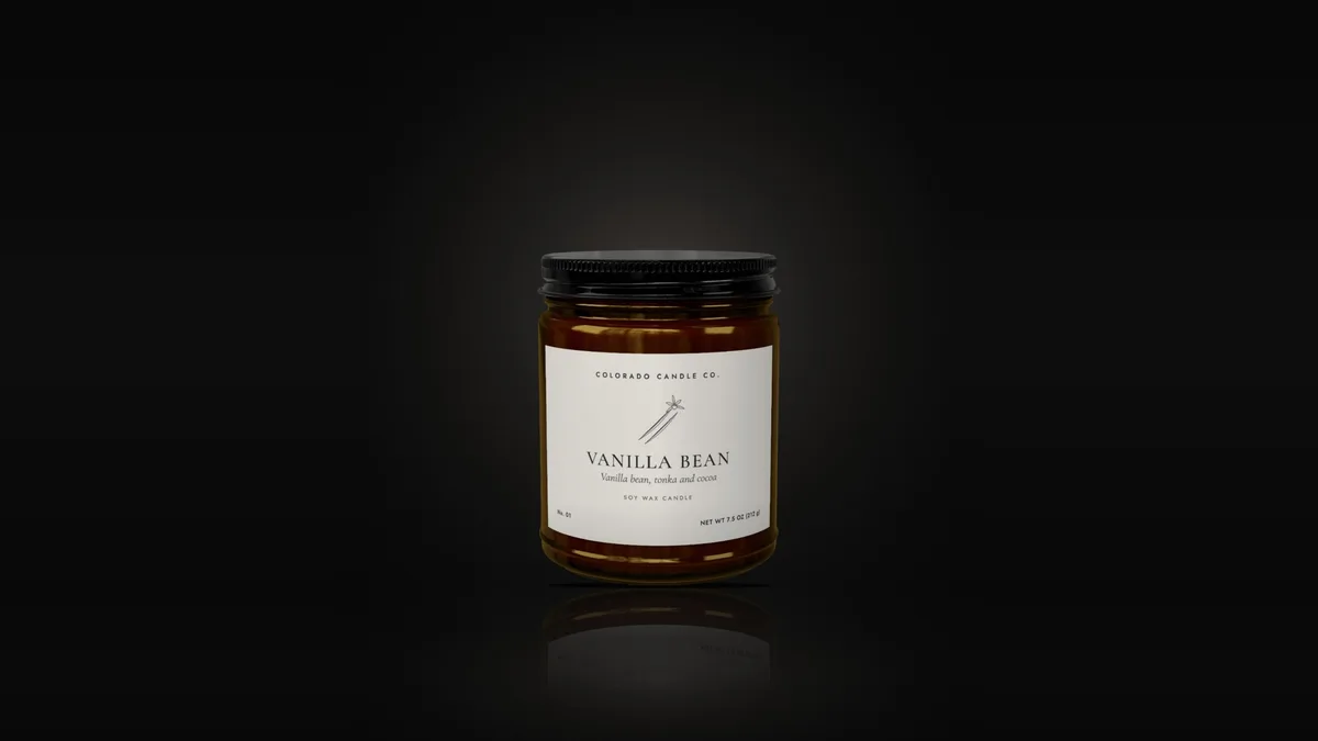 Vanilla Bean soy candle in an amber glass jar with a black lid