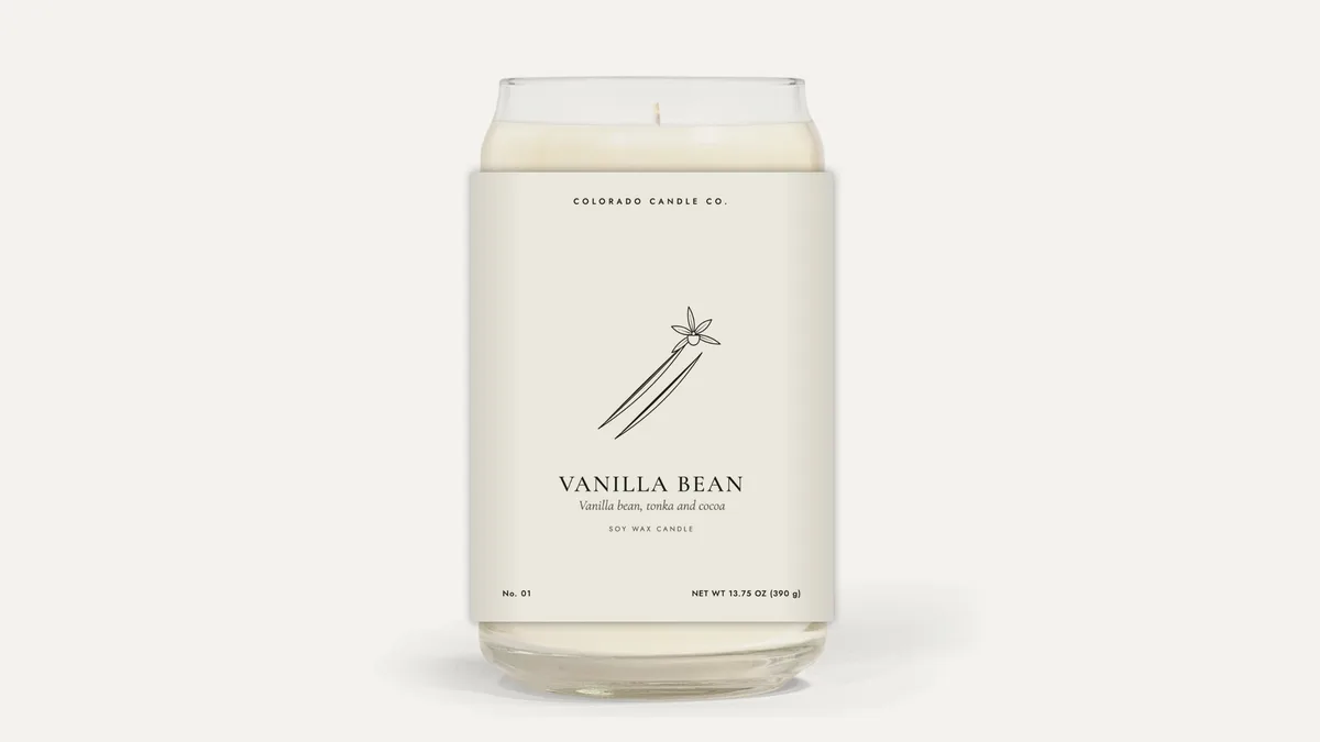 Vanilla Bean soy candle in a tall clear glass jar