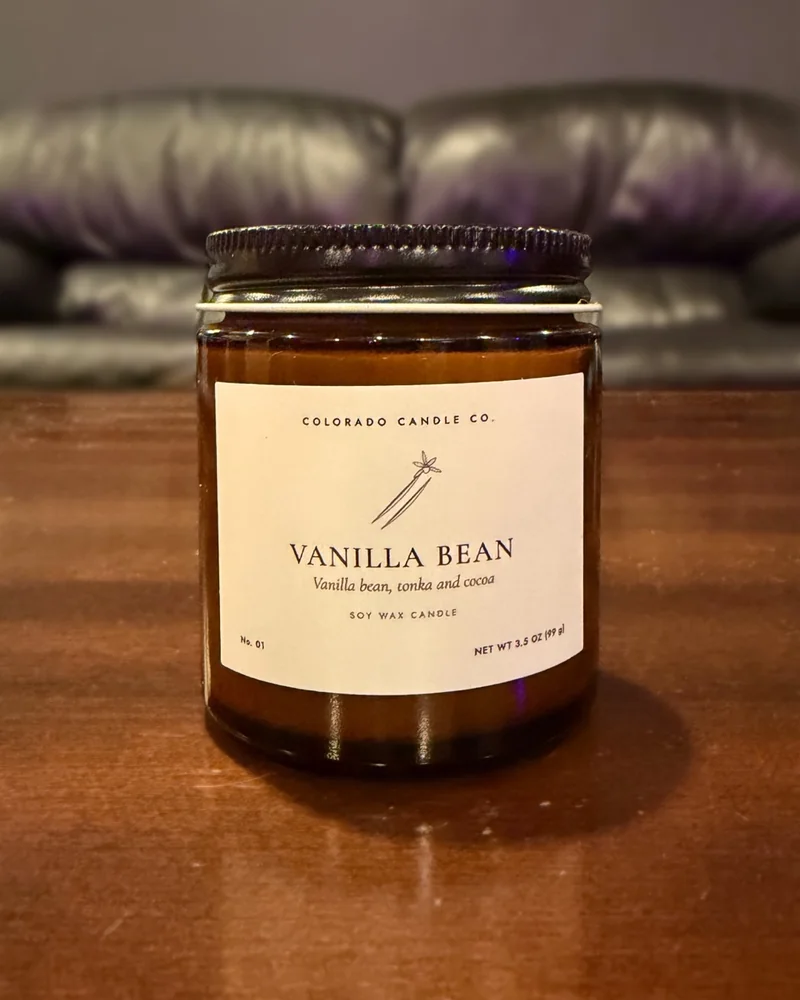 Vanilla Bean soy candle in a 4 oz amber glass jar with a black lid